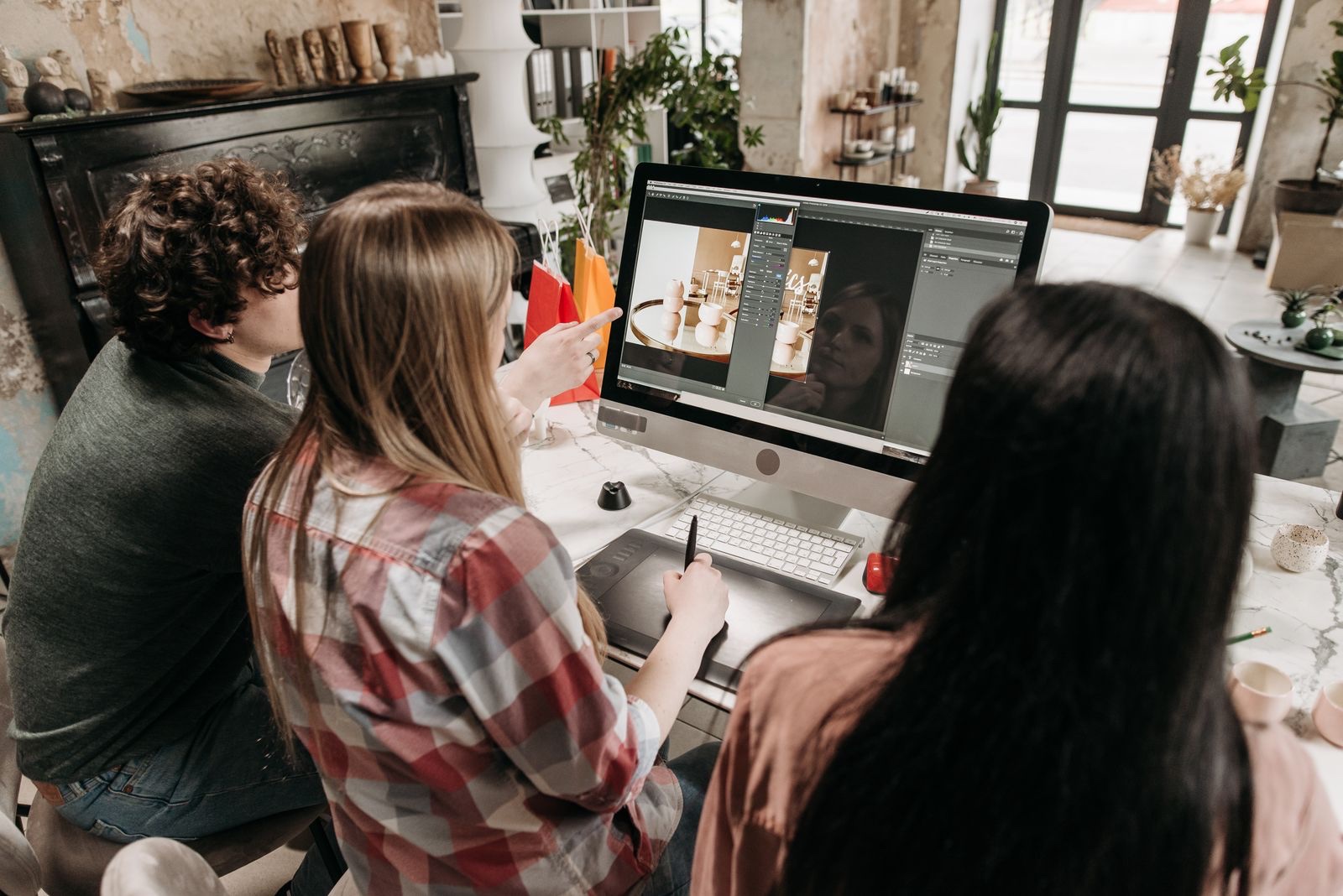 A creative team collaborating at a studio workstation